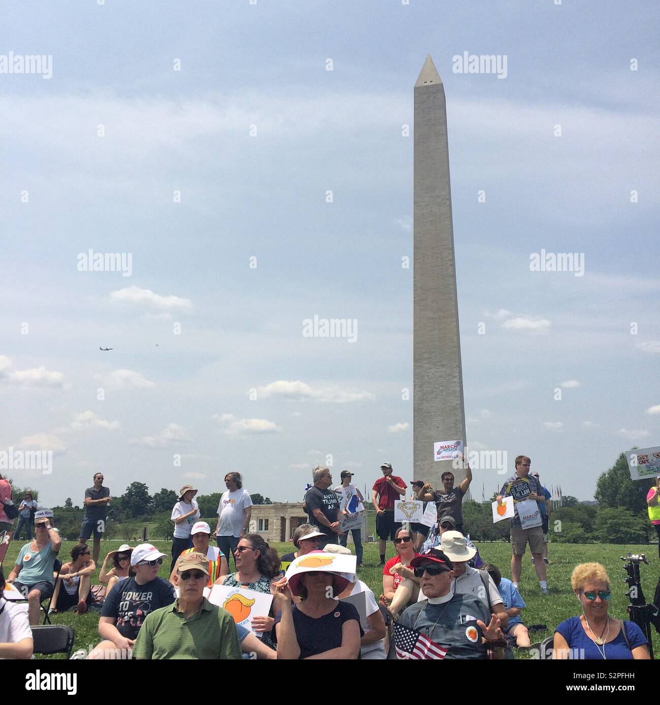 People listen to speakers on June 2, 2019, at the National March to Impeach Donald Trump, in Washington, D.C., United States - Smartphone Captured Stock Image