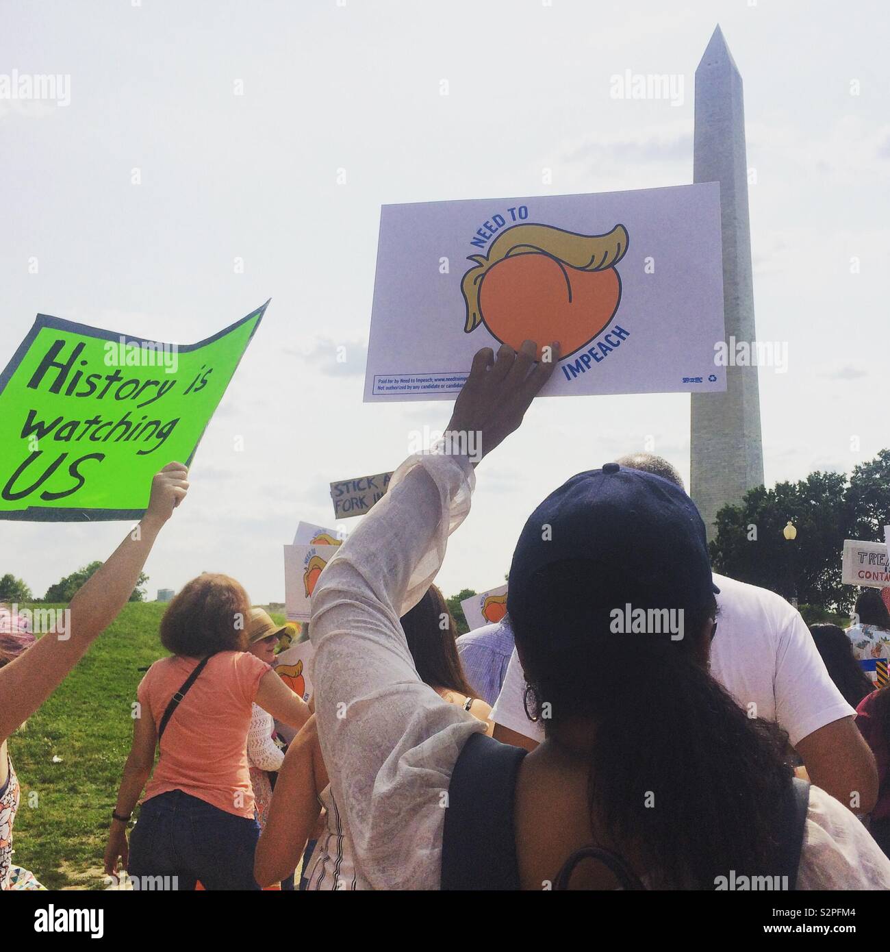 June 2, 2019, in Washington, D.C., United States. People near the Washington Monument at the National March to Impeach Donald Trump. - Smartphone Captured Stock Image