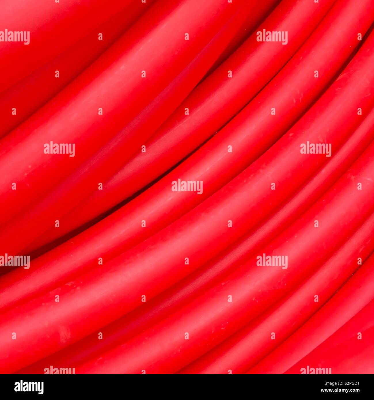 Red tubes as background Stock Photo - Alamy