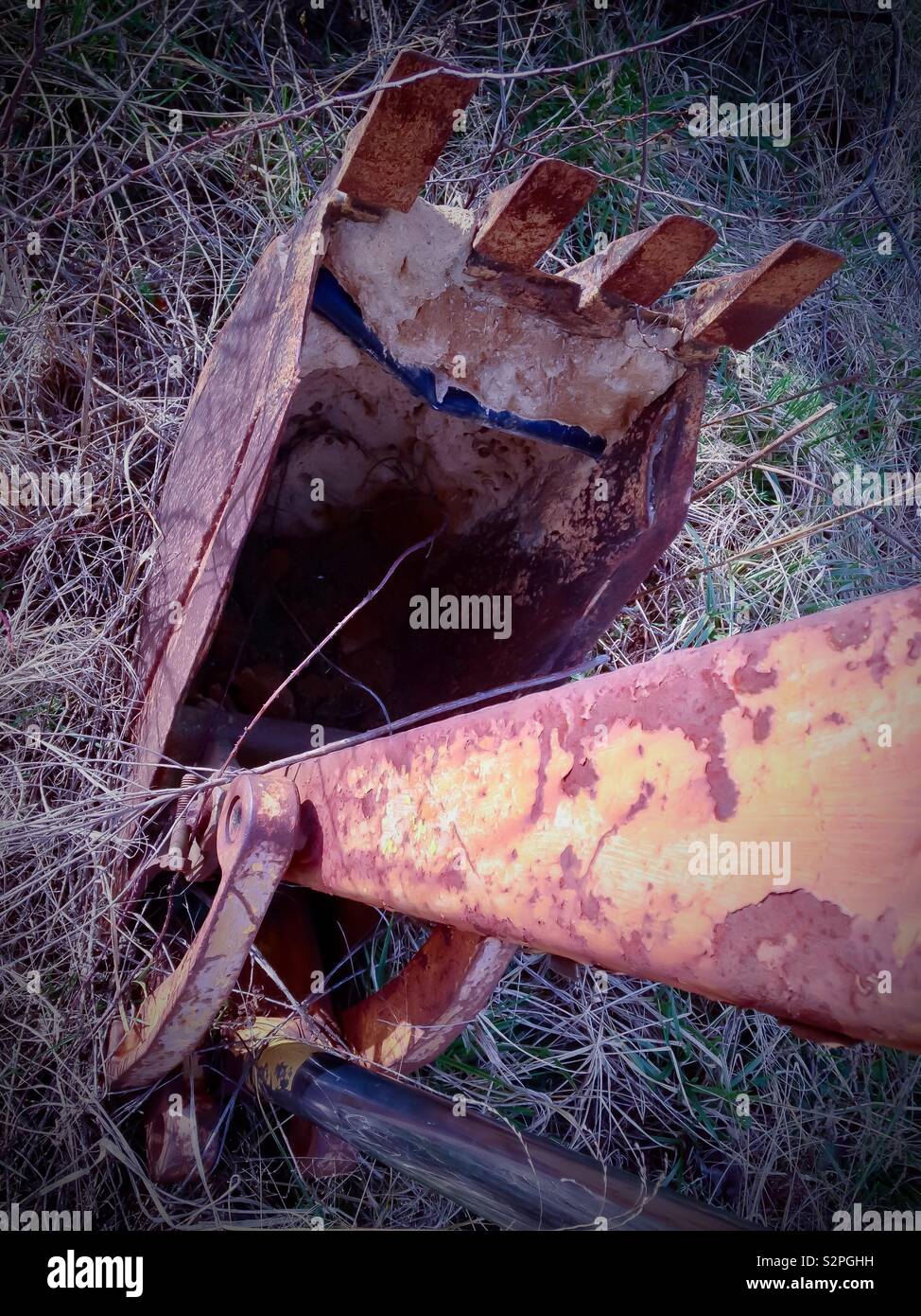 Looking down the arm of a rusty backhoe into the bucket - Smartphone Captured Stock Image