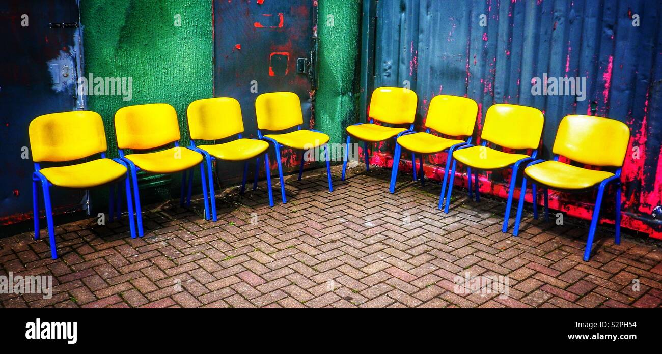 8 yellows plastic seats in a corner - Smartphone Captured Stock Image