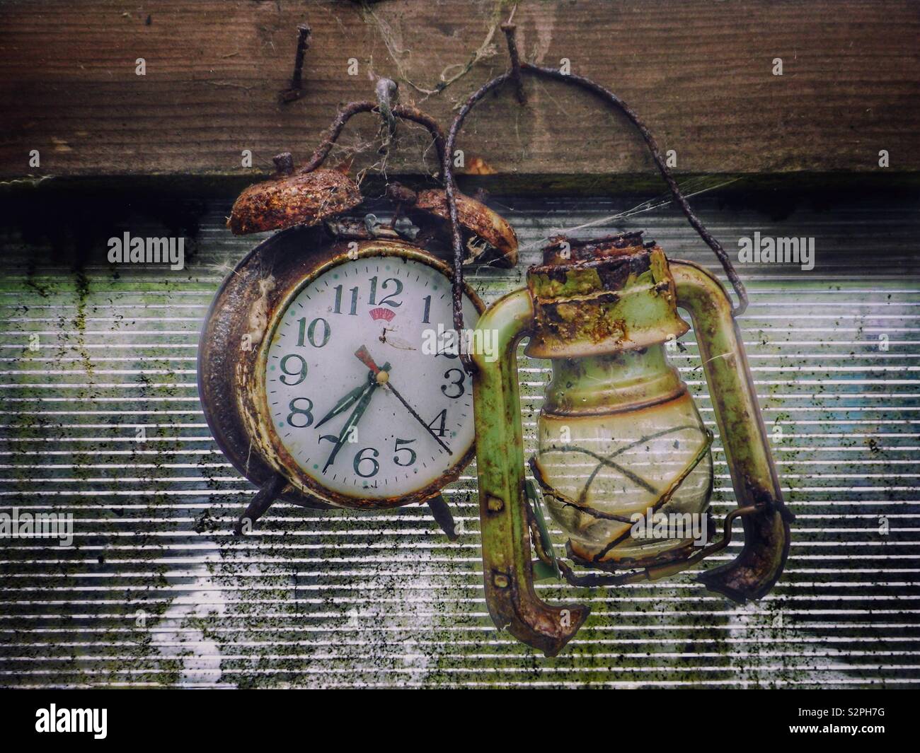 Rusty Broken Clock Rusty clock and broken lantern in an old garden shed Stock Photo - Alamy