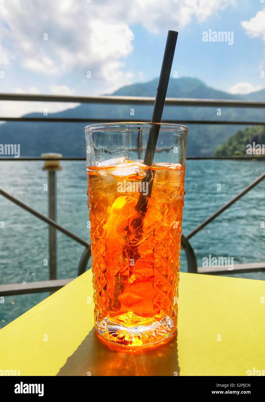 Aperol Spritz drink on a lakeside table - Smartphone Captured Stock Image