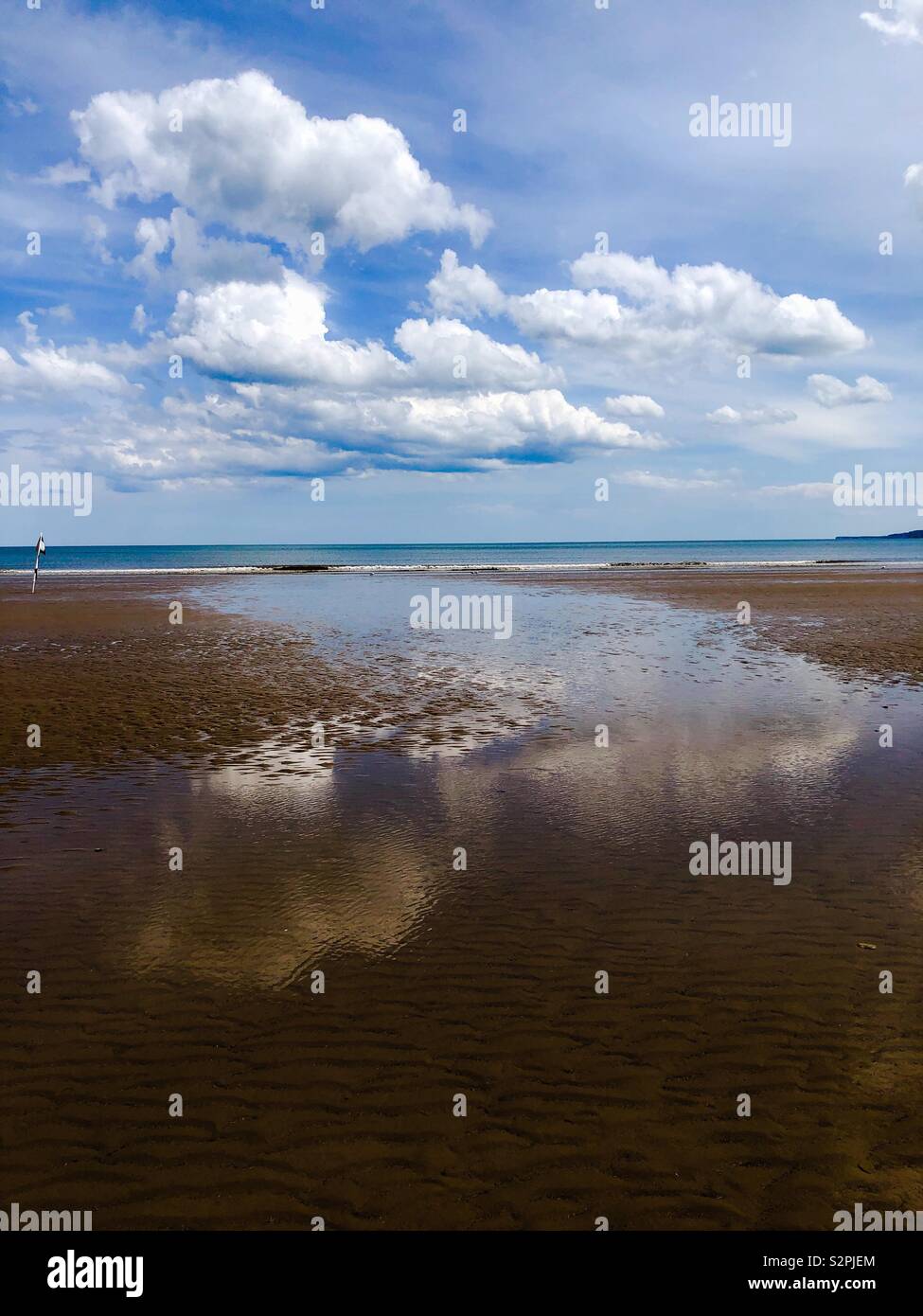 White cloud reflection on a wet beach - Smartphone Captured Stock Image