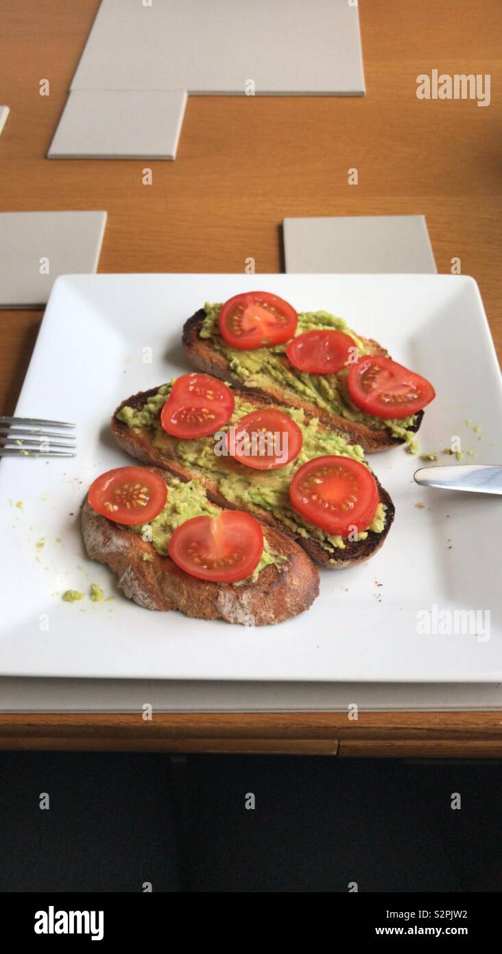 Avocado and tomato toast Stock Photo