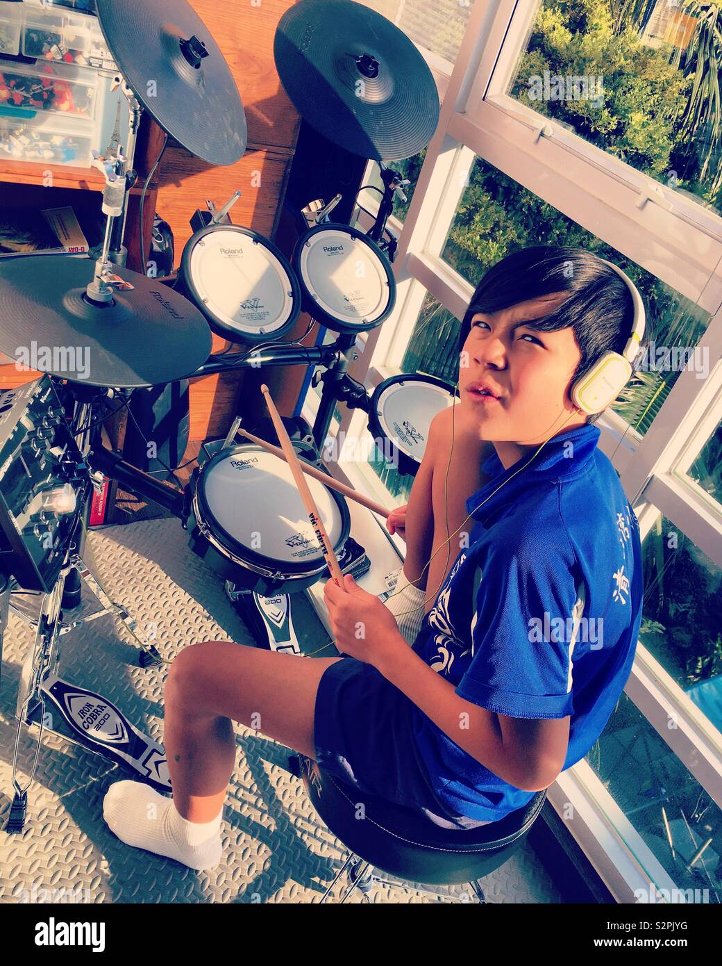 Young boy playing electric battery or drums Stock Photo