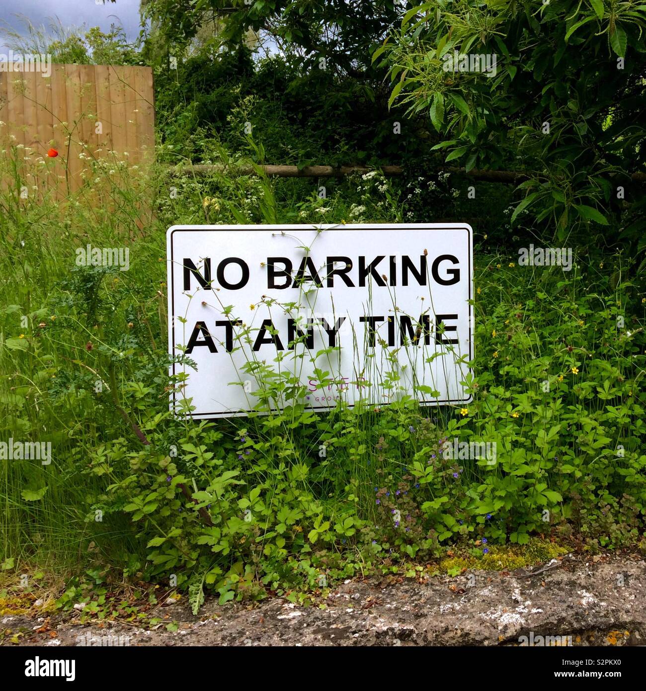 Altered signage : no barking at any time Stock Photo