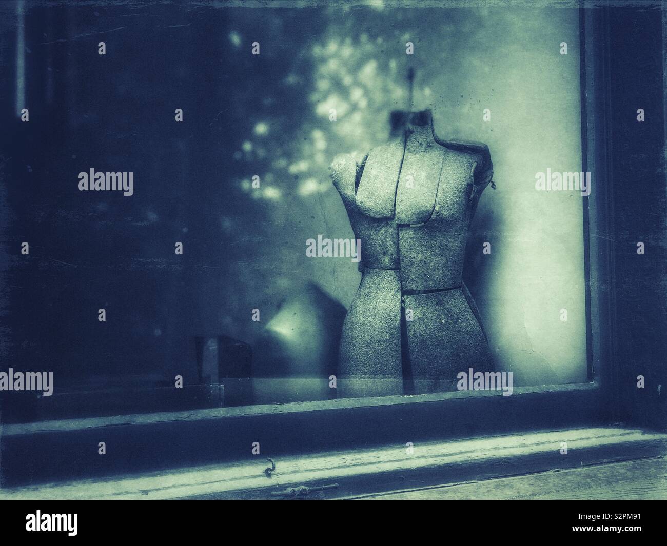 Old dress form in a shop window - Smartphone Captured Stock Image