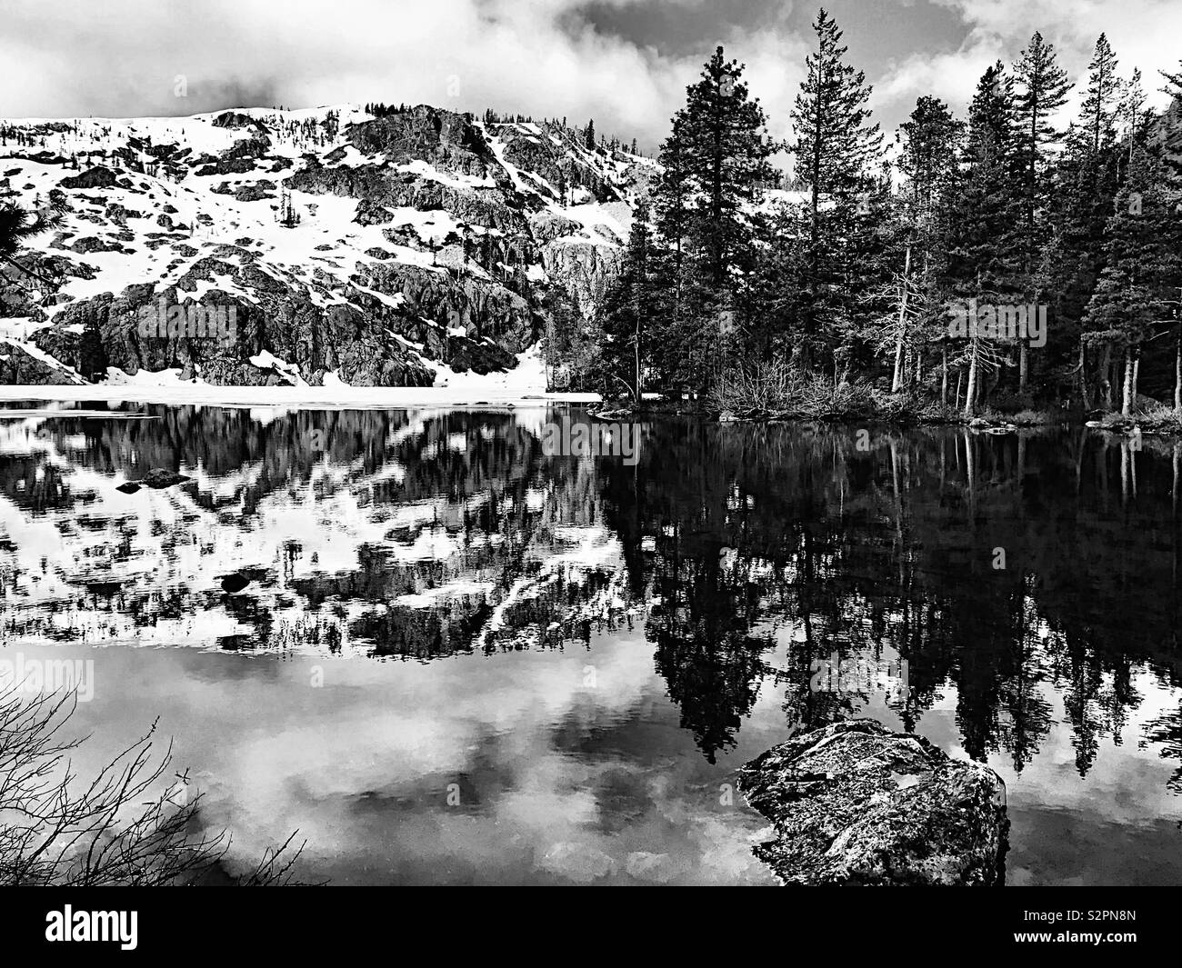 Reflections of mountain lake at ice-out, in black and white - Smartphone Captured Stock Image