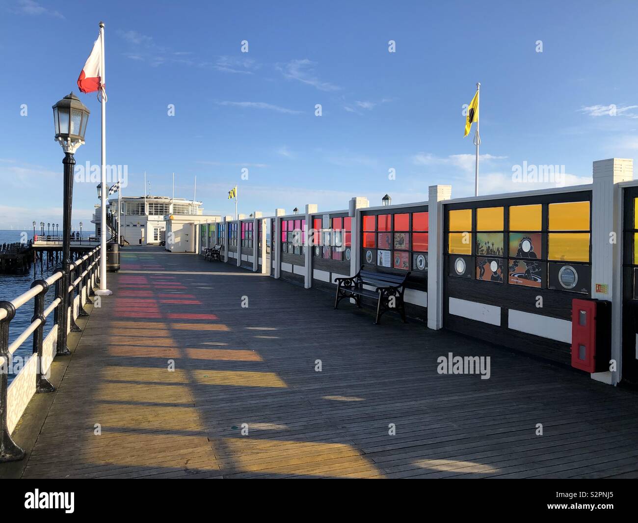 Sun casting colourful shadows on Worthing Pier Stock Photo