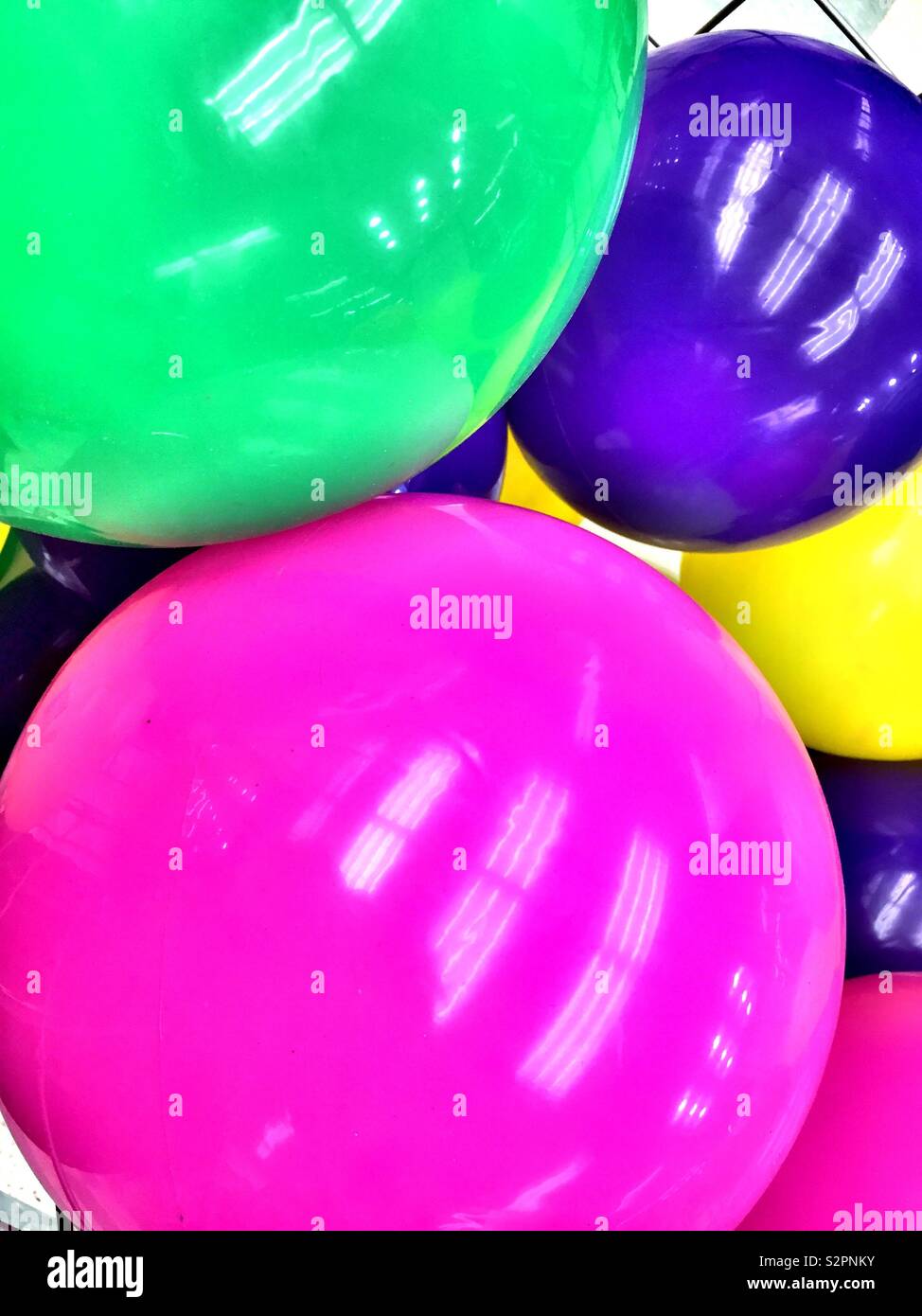 Sales display of multi colored rubber balls at a Department store, USA - Smartphone Captured Stock Image