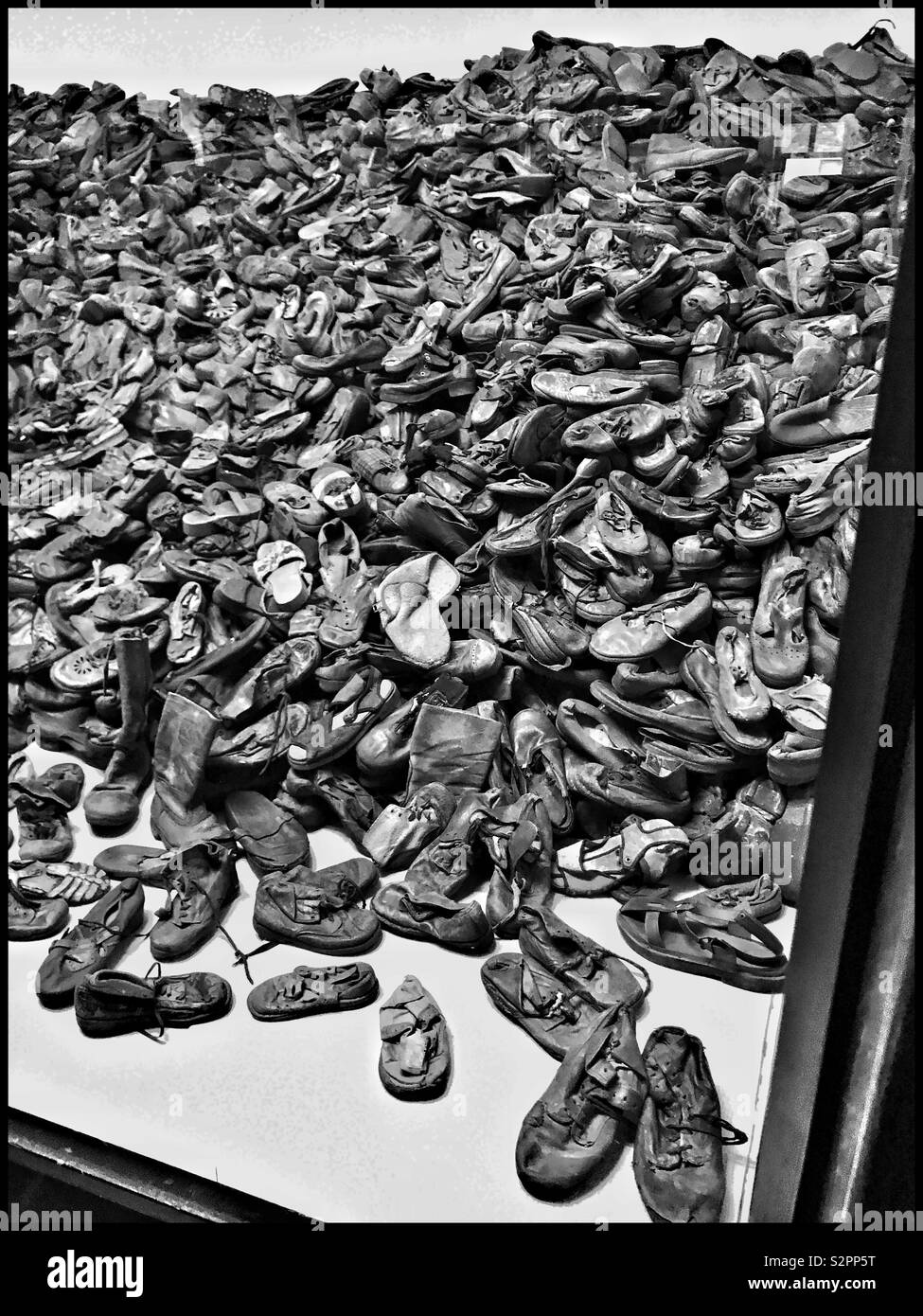 An unbelievable sight - a massive pile of confiscated shoes: owned by victims of the Nazi Genocide. Part of a display at the former Auschwitz Concentration Camp that is now a Memorial Museum. Pic.© CH - Smartphone Captured Stock Image