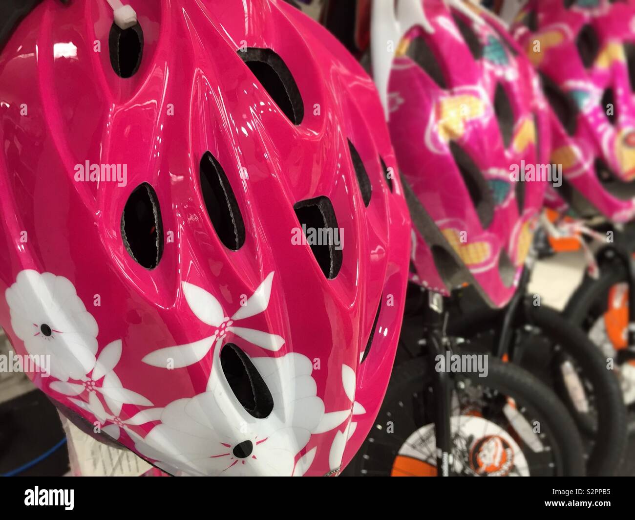 Children’s plastic protective bicycle helmets for sale in a department store, USA - Smartphone Captured Stock Image