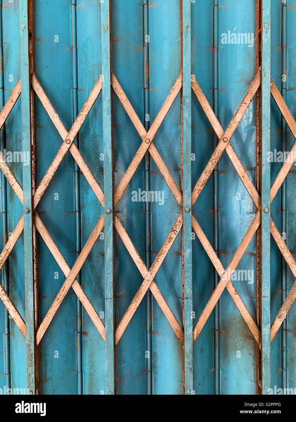 Blue door or shut with gold diamond shape grid in front - Smartphone Captured Stock Image