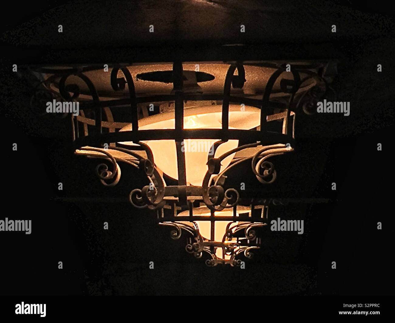 Antique ceiling light with decorative security railing. - Smartphone Captured Stock Image