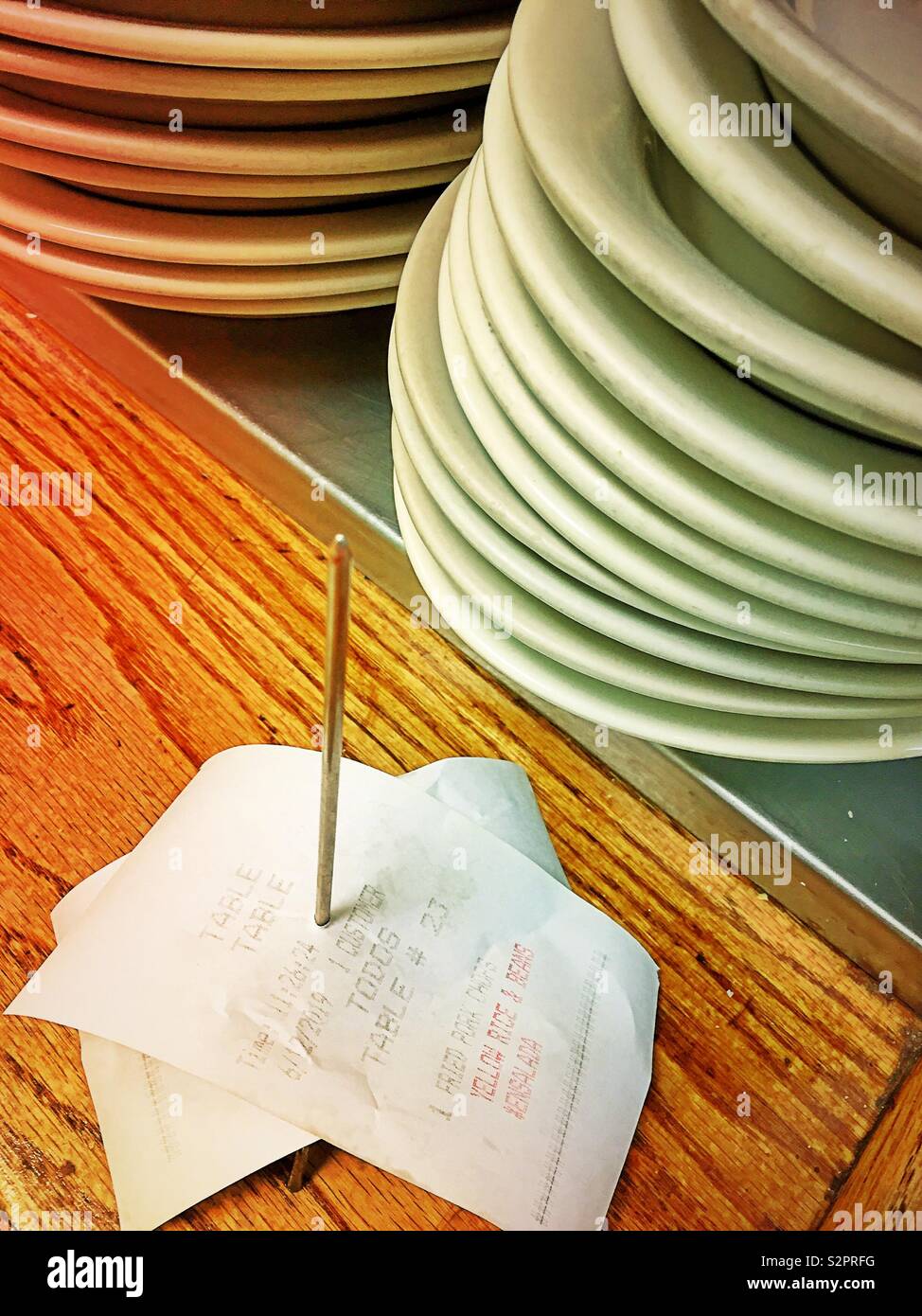 Restaurant counter close up of order spindle and plates, USA - Smartphone Captured Stock Image