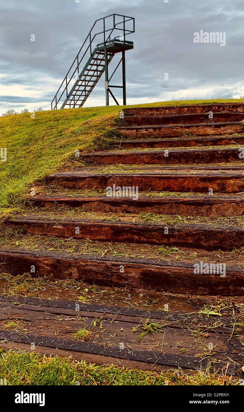 Steps leading up to tee on golf course with observation stairway in background Stock Photo