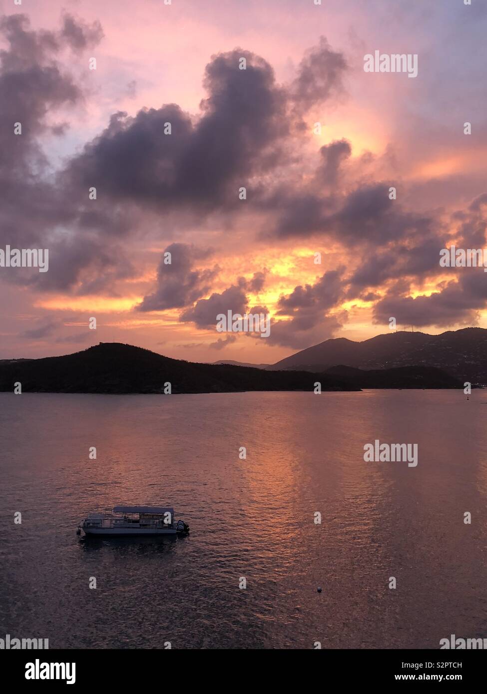 The sun sets over the harbor of Charlotte Amalie on the island of St. Thomas in the U.S. Virgin Islands. - Smartphone Captured Stock Image