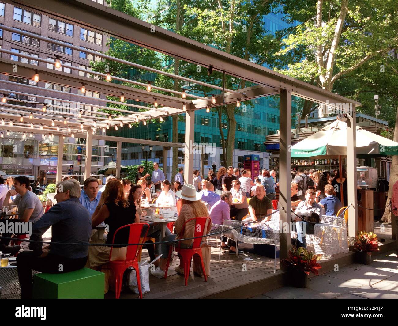 Diners at that Southwest porch, a restaurant in Bryant Park, NYC, USA - Smartphone Captured Stock Image