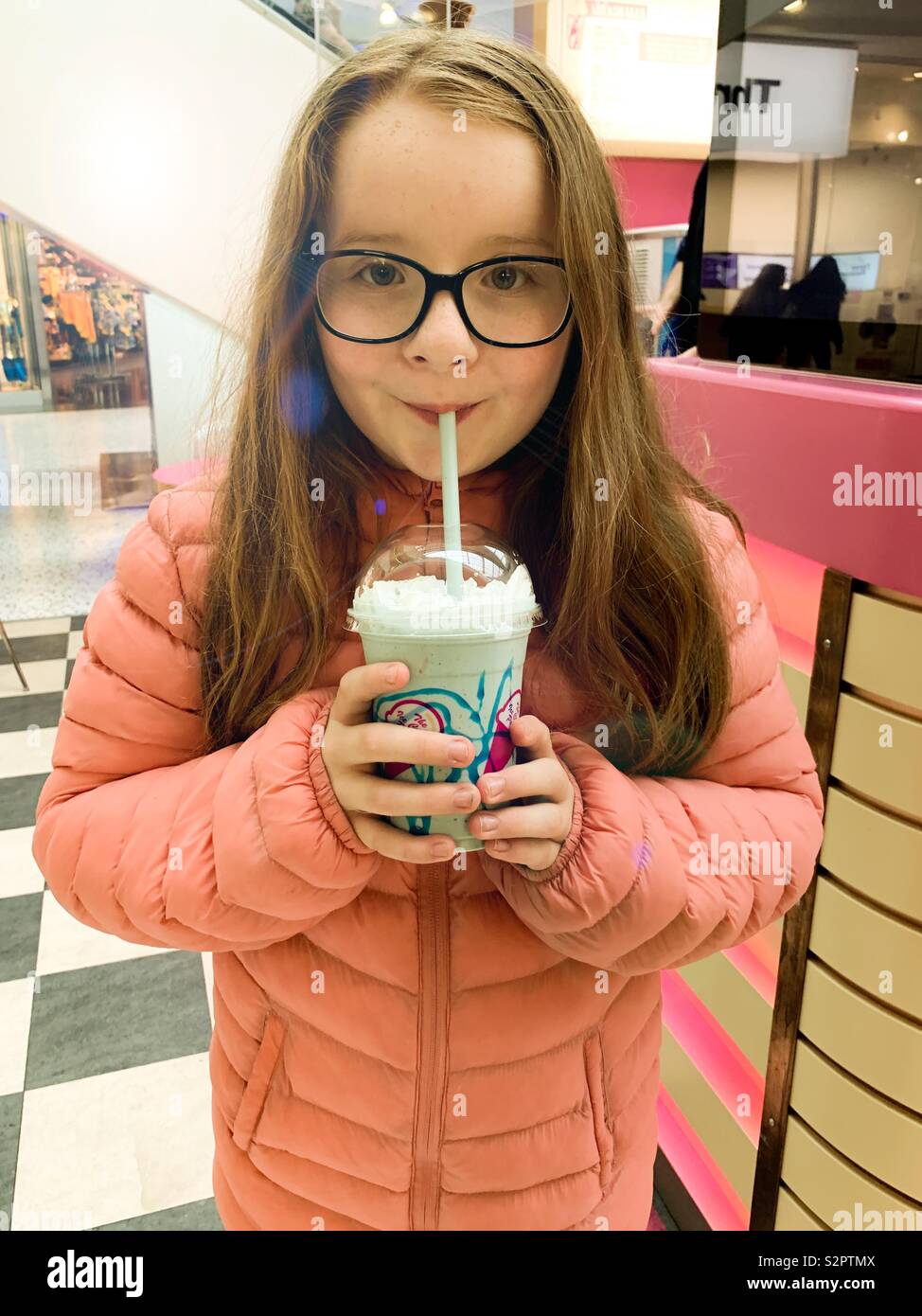 Young girl drinking milkshake Stock Photo