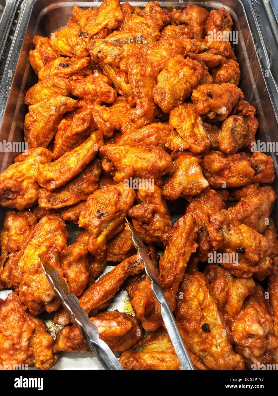 Fresh delicious tasty fried spicy hot chicken wings. Stock Photo