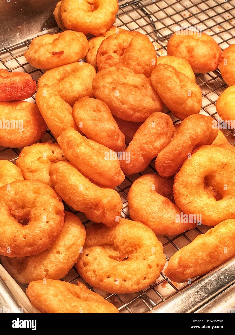 Many fresh delicious plain donuts just pulled out of the fryer. - Smartphone Captured Stock Image