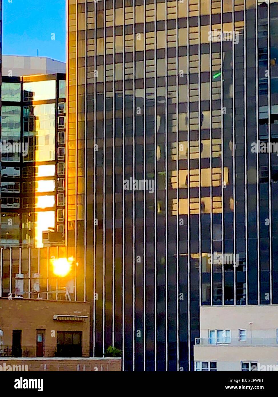 Reflected sunrise on New York office buildings Stock Photo