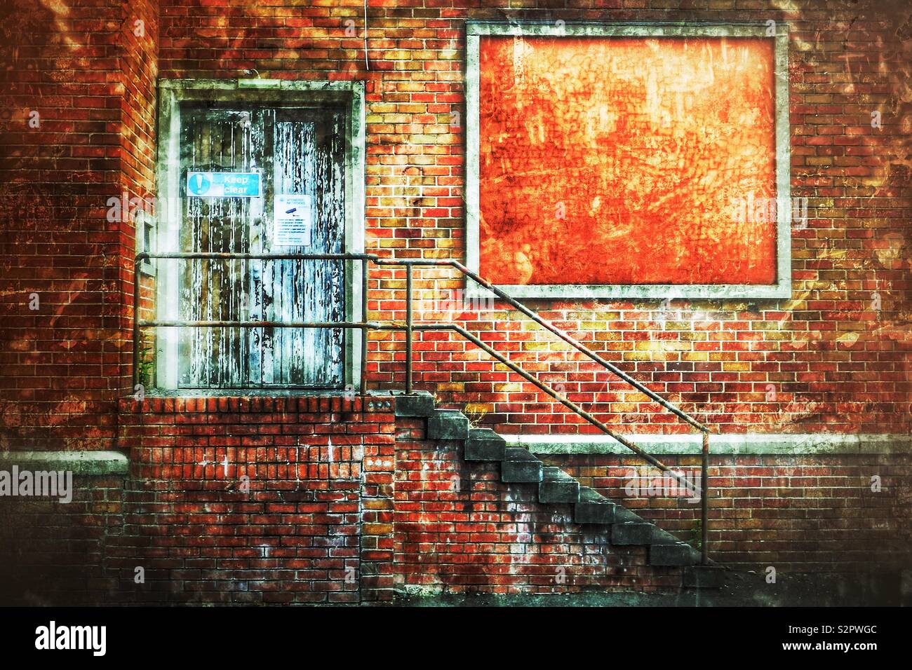 Derelict factory with blank notice board with locked door and access stairway - Smartphone Captured Stock Image