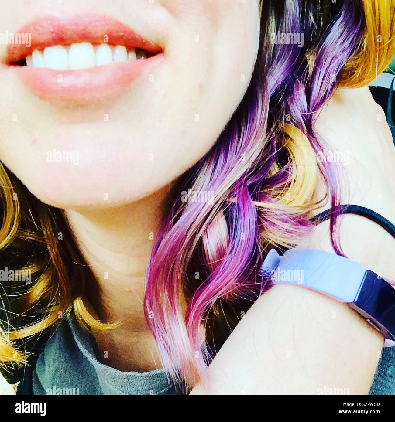 Smiling woman with blonde and purple hair. - Smartphone Captured Stock Image
