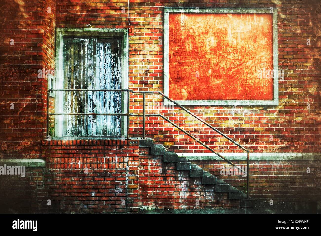 Derelict factory and empty bill board, locked door and stairway with hand rail - Smartphone Captured Stock Image