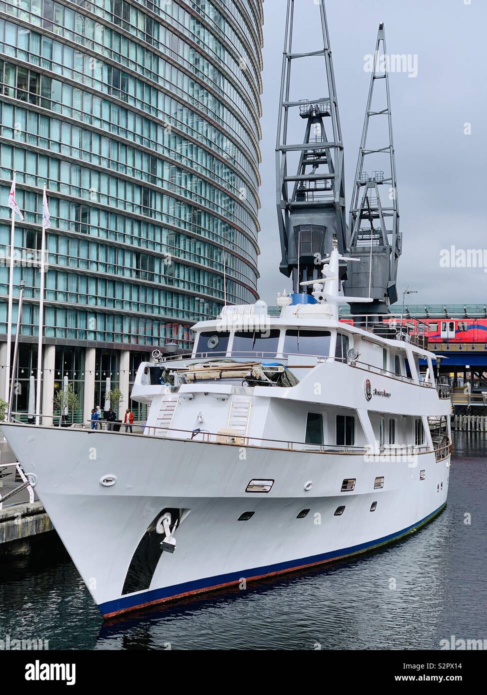 London, UK - 15th June 2019: The Absolute Pleasure super yacht hotel moored up in front of the Marriott hotel at Canary Wharf. Stock Photo