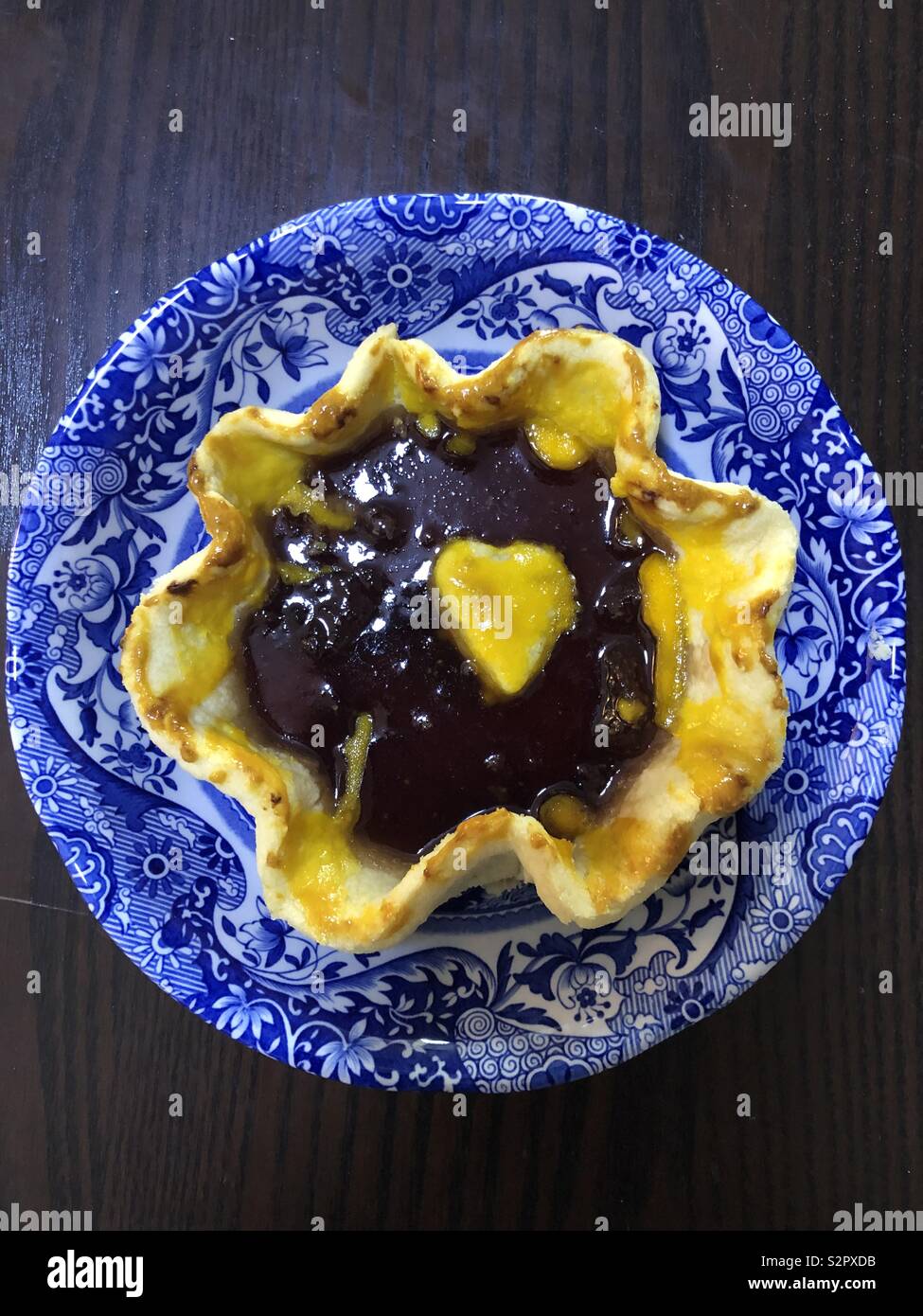 Homemade jam tart in a blue bowl Stock Photo