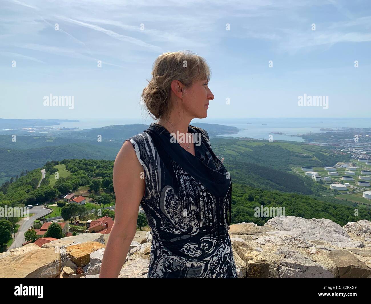 Woman looking at the horizon from the top of a castle wall. - Smartphone Captured Stock Image