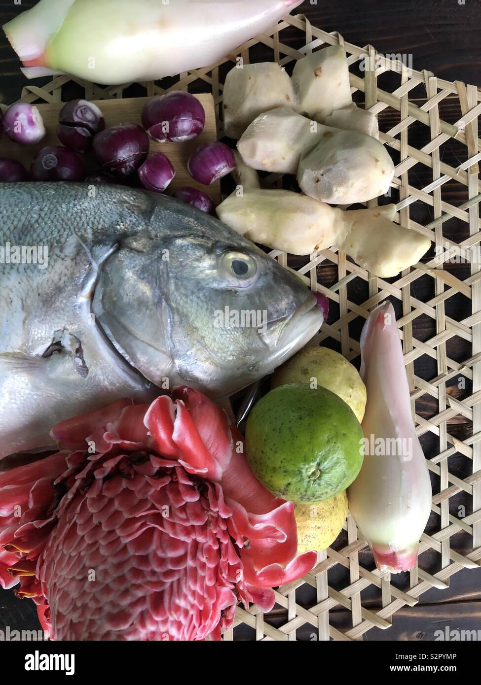 North Borneo local delicacy, Hinava ingredients, White fish, ginger, red onion, torch ginger and limes Stock Photo