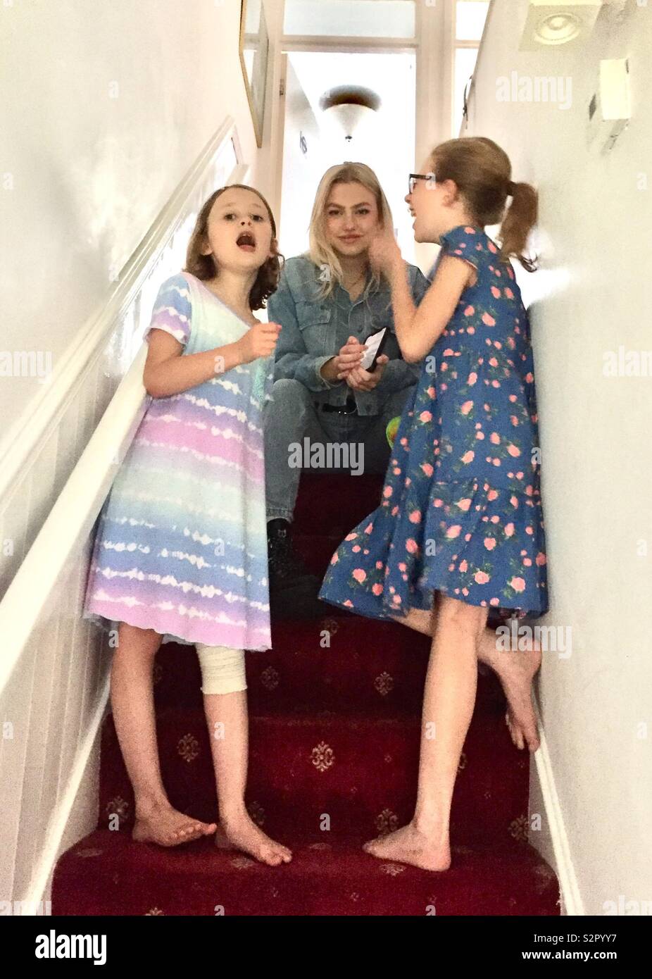Sisters on the stairs at home - Smartphone Captured Stock Image