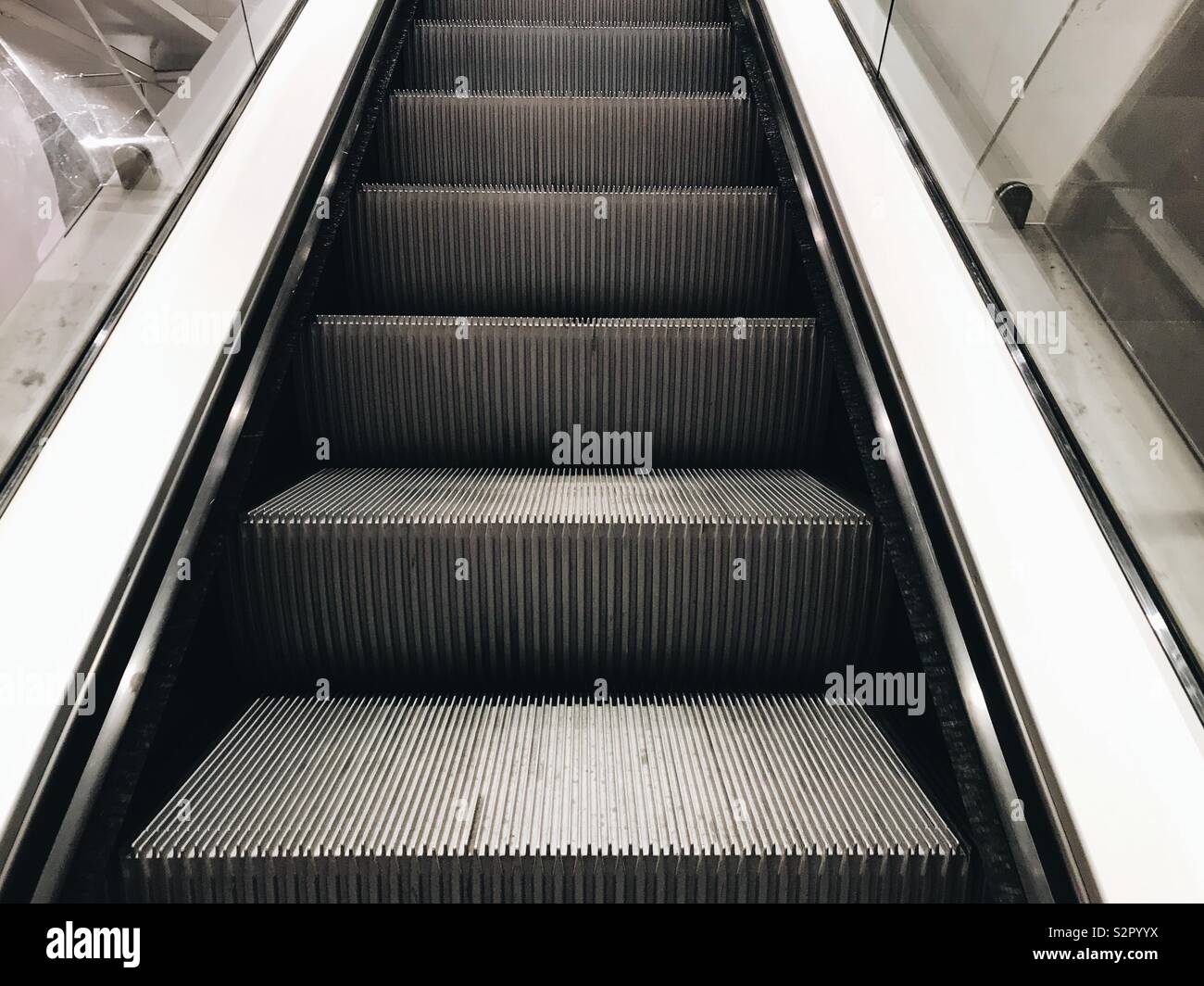 Escalator leading upwards in a shop. - Smartphone Captured Stock Image