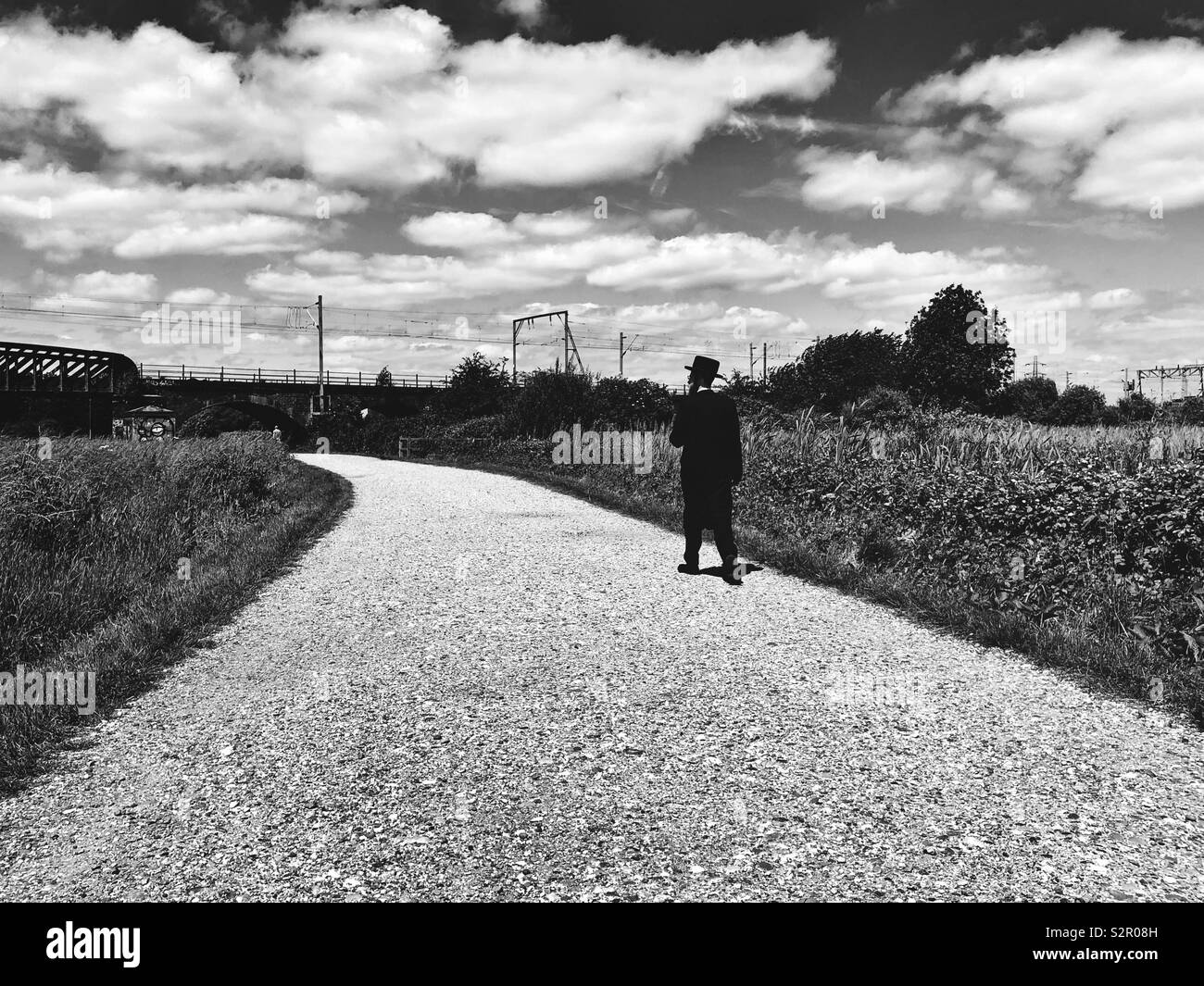 Man walking on a path in Hackney Marshes in East London Stock Photo