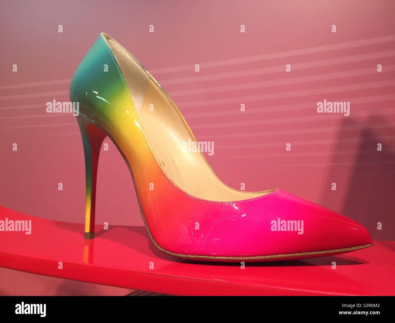 Christian Louboutin vibrantly colored high-heeled shoe on sale in a  department store, NYC, USA Stock Photo - Alamy