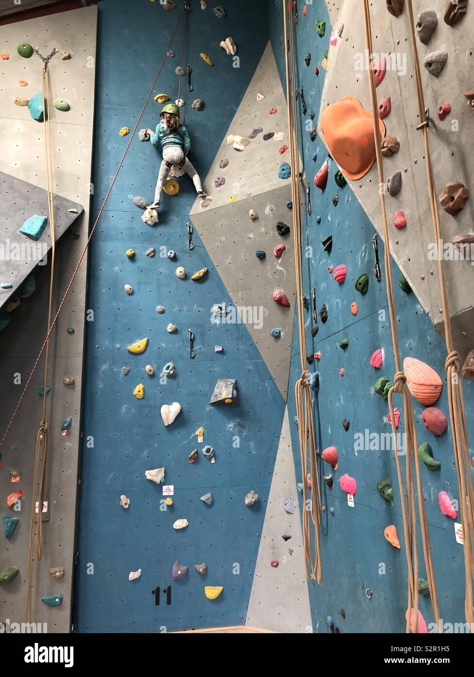 Little girl on climbing wall Stock Photo