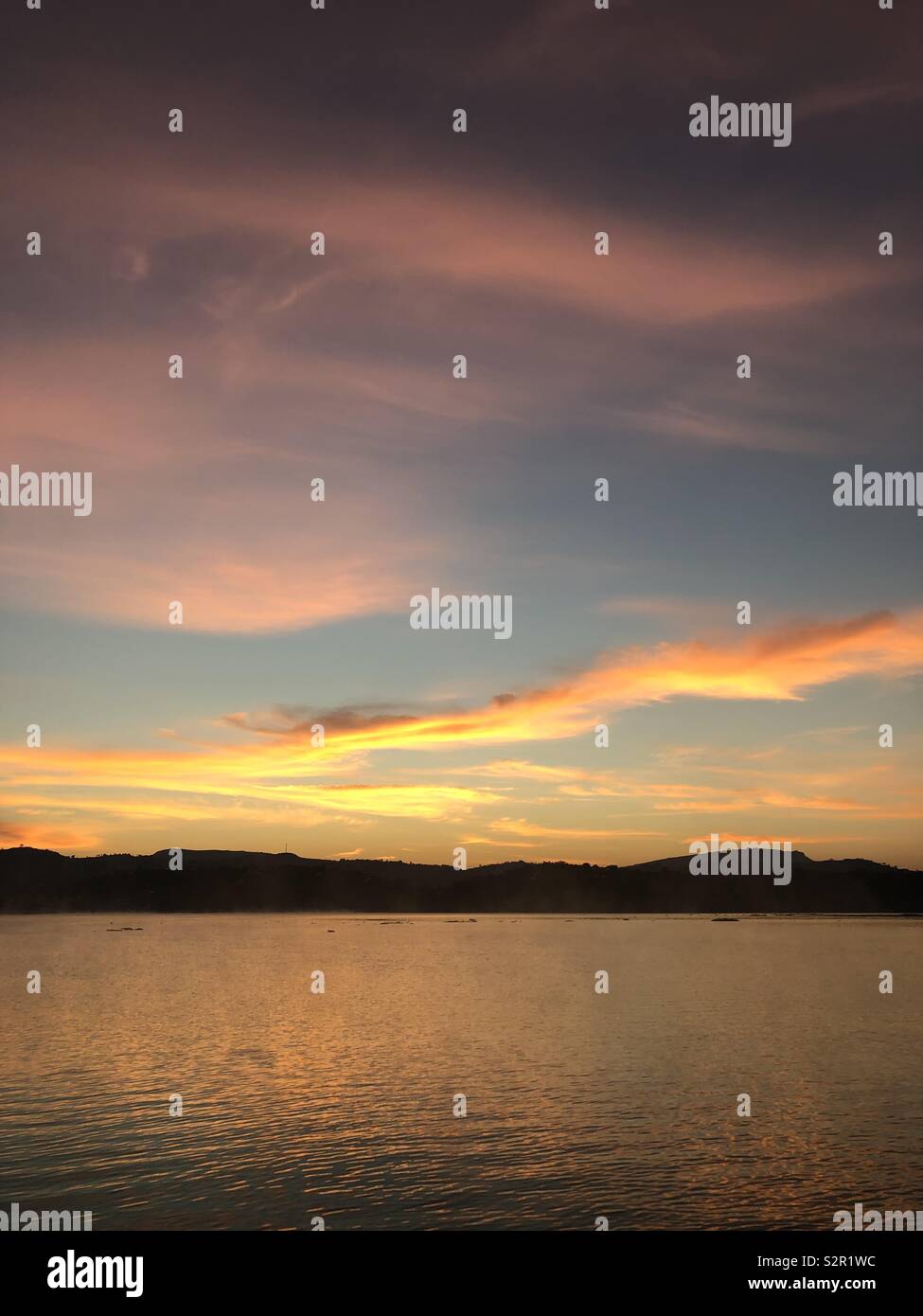 Sunrise over the dam, positive vibes to take you through the day. - Smartphone Captured Stock Image