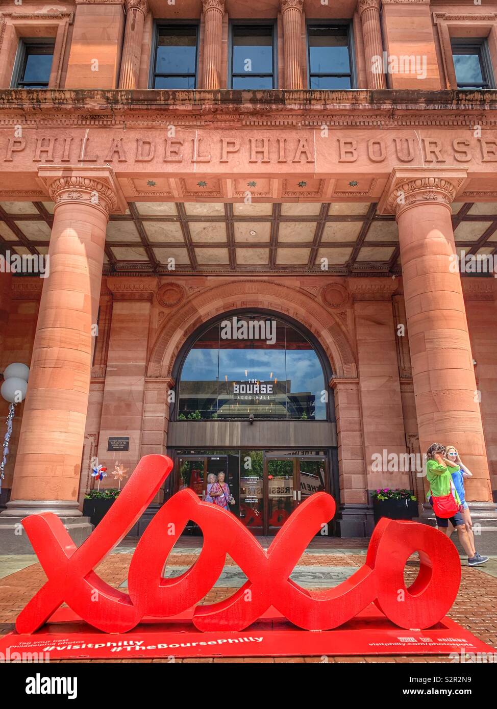 The Philadelphia Bourse - Historic Building now food hall with xoxo Love symbol sculpture, Philadelphia, Pennsylvania, USA Stock Photo