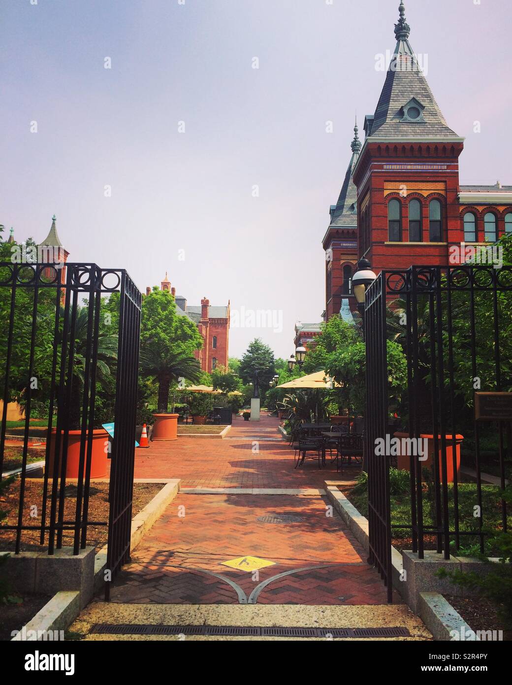 Enid A Haupt Garden and the Arts and Industries Building (right,) Smithsonian Institution, Washington, D.C., United States Stock Photo