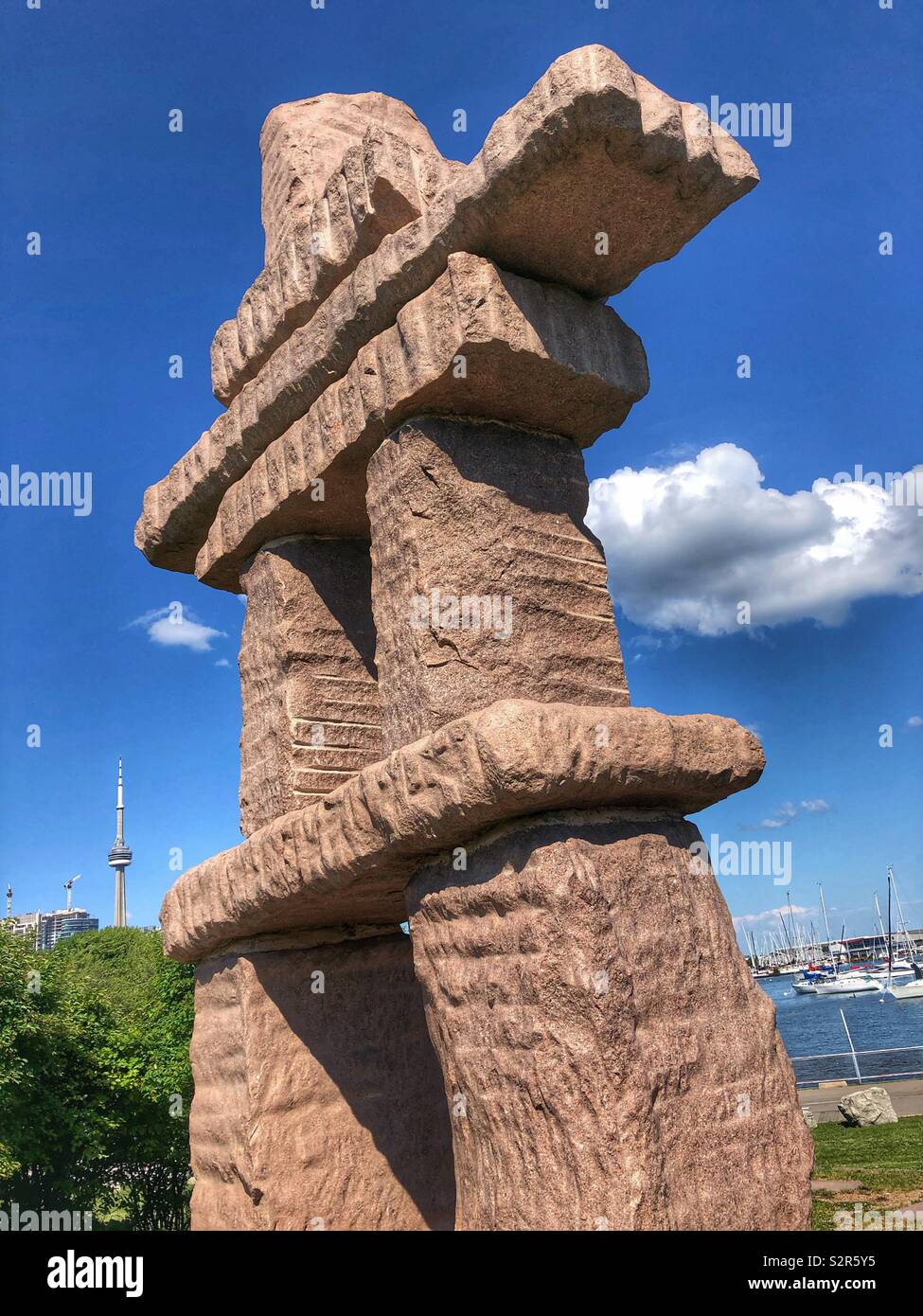 Two iconic symbols in Toronto, the CN Tower and the Inuit Inukshuk. Stock Photo