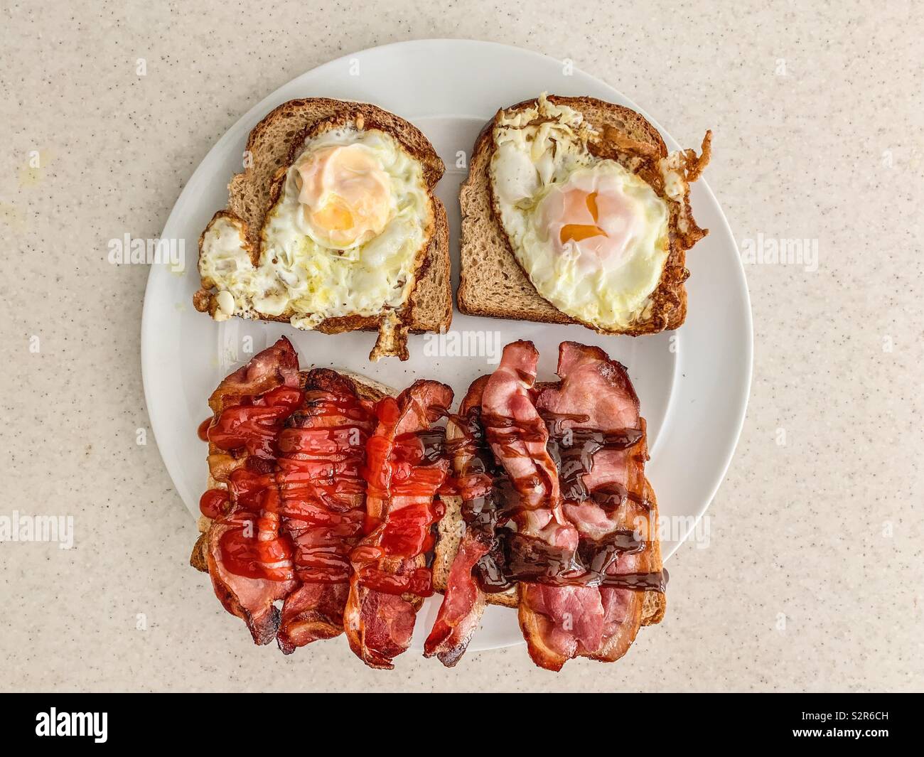 Egg and bacon sandwich on wholemeal brown bread Stock Photo