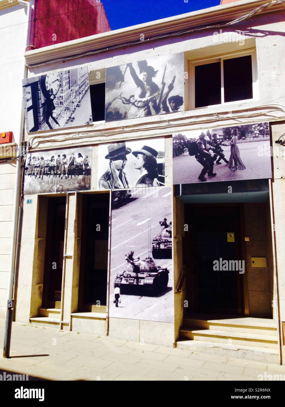 Different historic pictures outside building wall - Smartphone Captured Stock Image