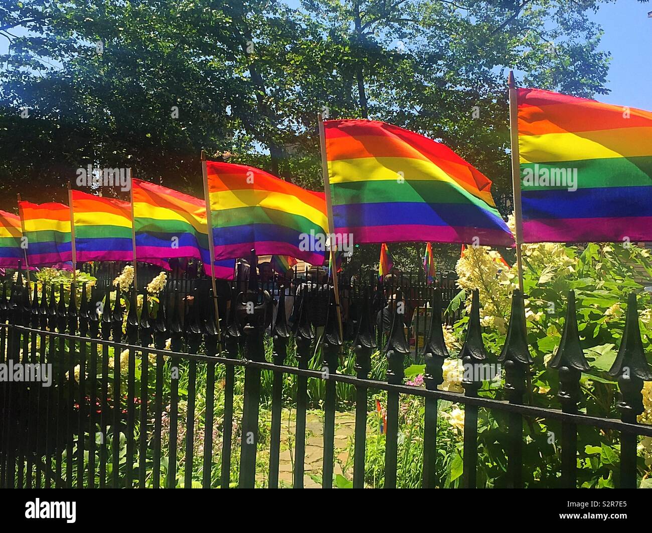 WorldPride Rainbow flags at the Stonewall national Monument, Greenwich village, New York City, USA - Smartphone Captured Stock Image