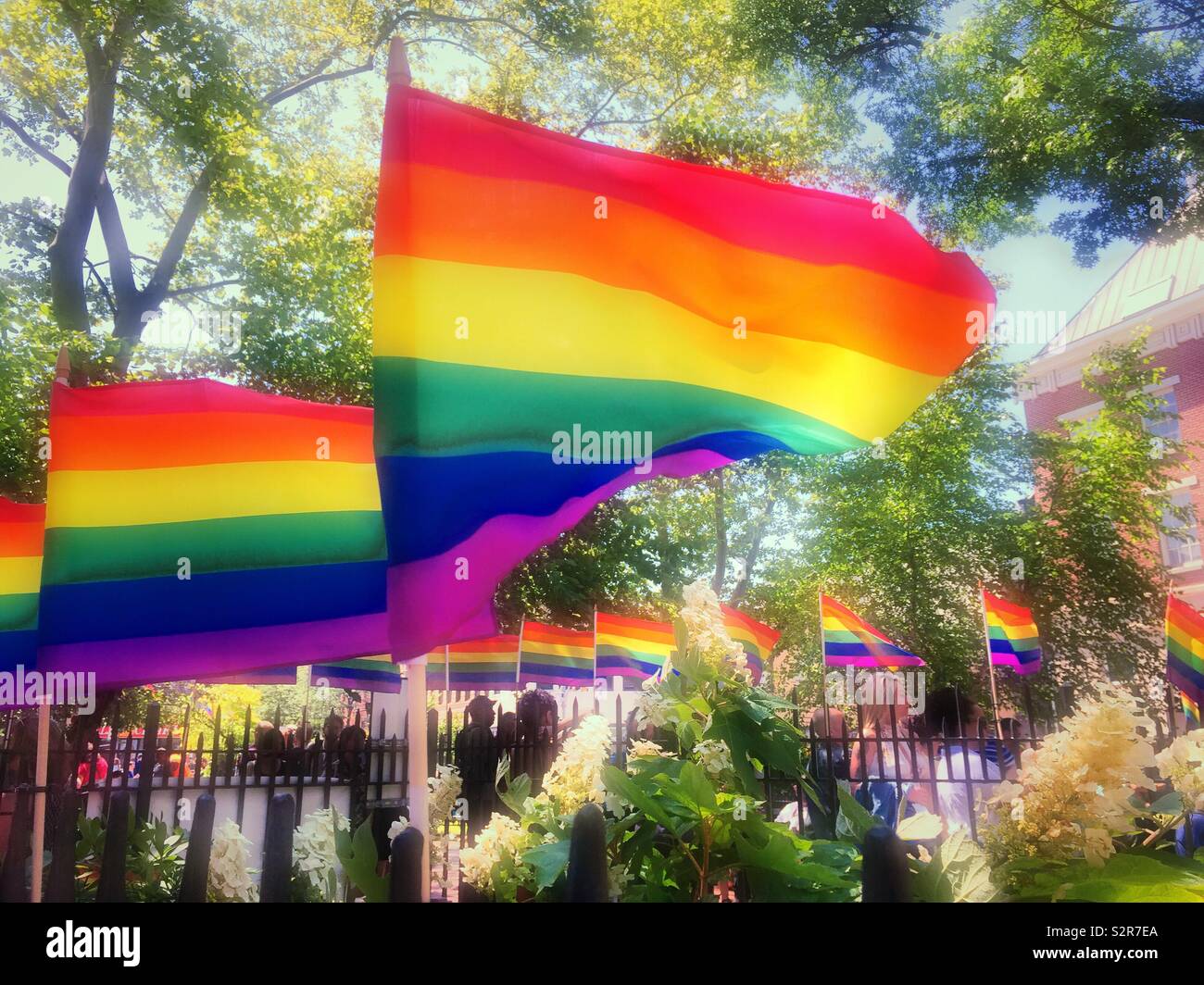 Worldpride rainbow flags at the Stonewall national Monument, Greenwich village, New York City, USA - Smartphone Captured Stock Image
