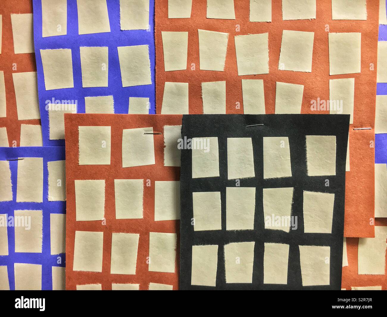 City of tall buildings created out of black, blue, and orange construction paper with beige windows. - Smartphone Captured Stock Image