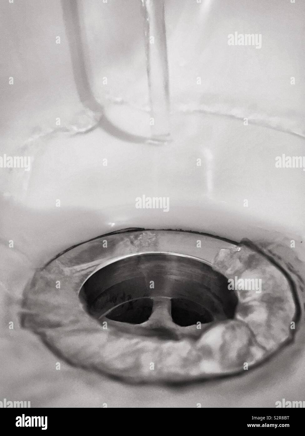 Water down the drain.  Washed away. Running water tap - Smartphone Captured Stock Image