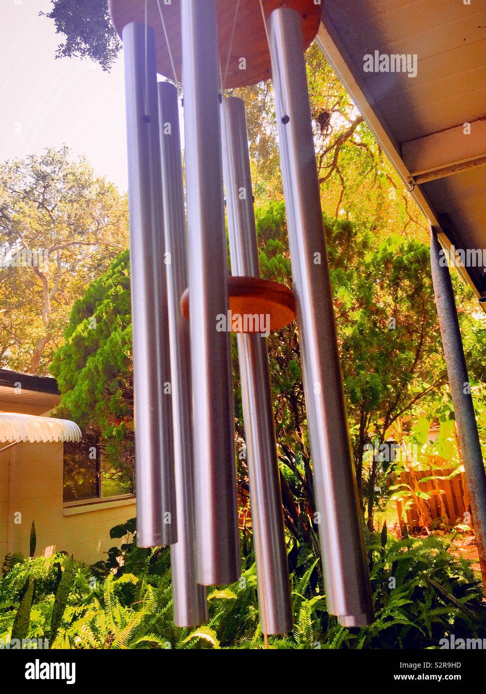 Wind chimes hanging in a suburban patio, USA Stock Photo